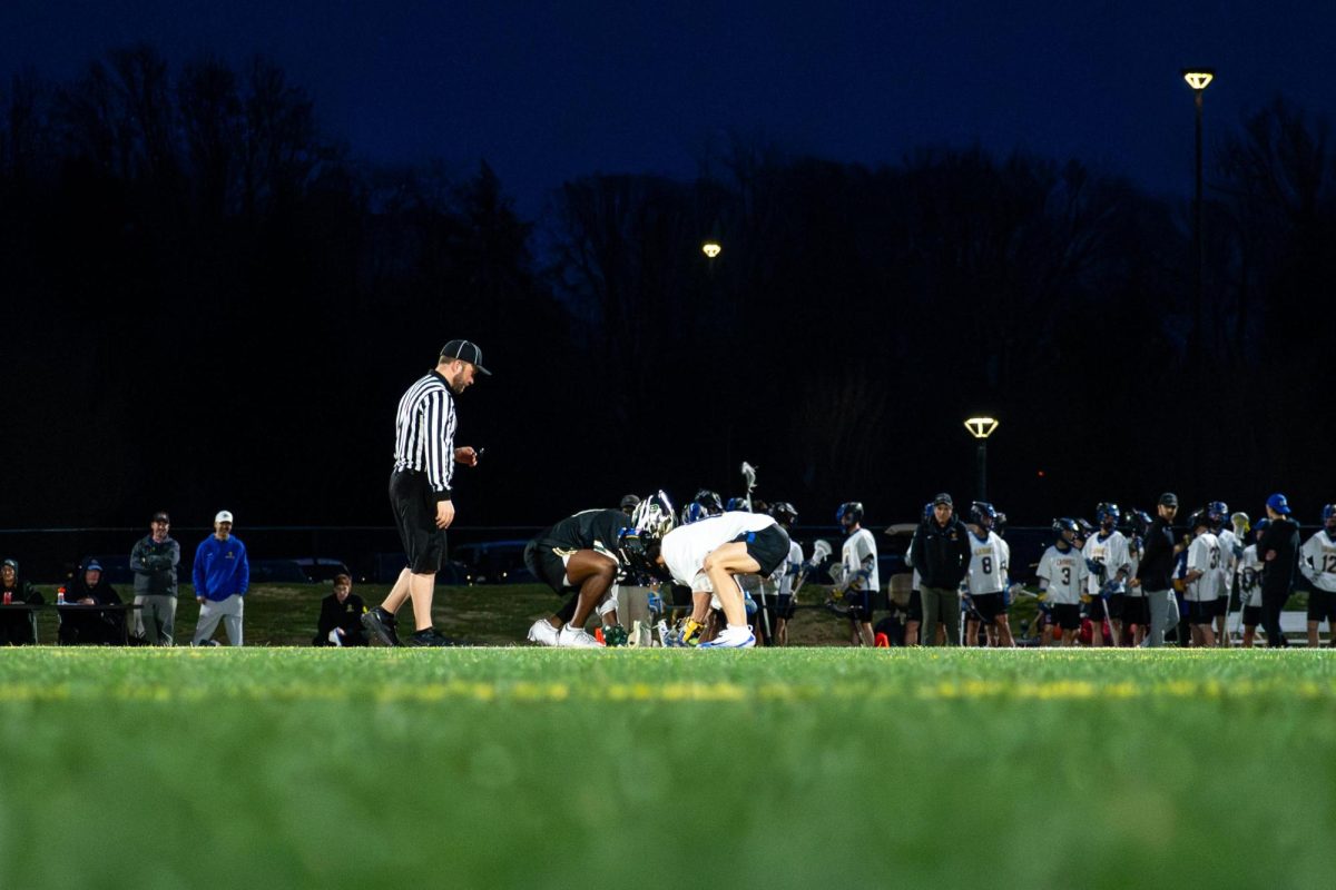 Junior Eli Chappa (#11) faces off at midfield in the 2026 Jack Meachum Classic.